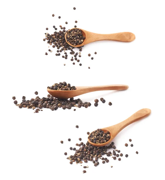 Wooden spoon and black peppercorn — Stock Photo, Image