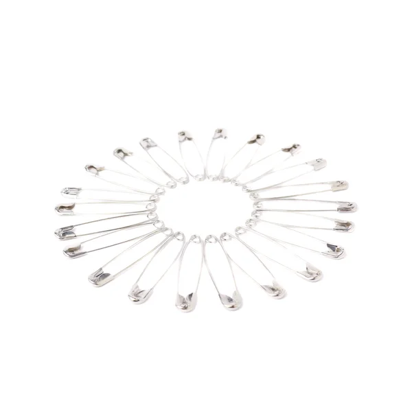 Round frame made of safety pins — Stock Photo, Image