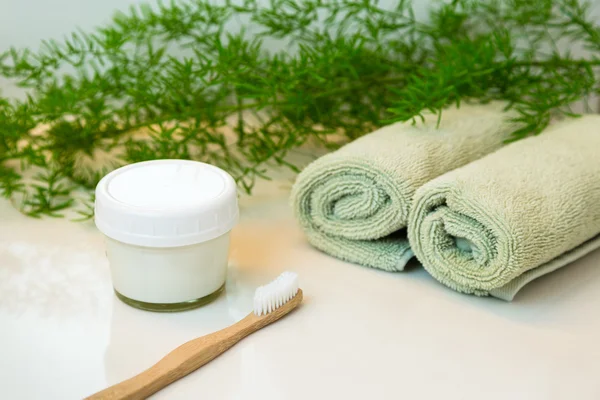 Homemade toothpaste and bamboo toothbrush, towels and greens on Stock Picture