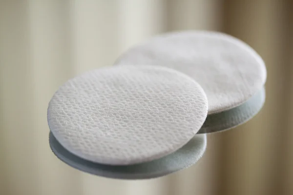 Cotton round cosmetic pads on reflective surface, close-up Royalty Free Stock Images