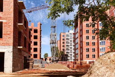 İnşaat alanında bir vinç ve kum yığını var. Yeni yerleşim alanının geliştirilmesi.