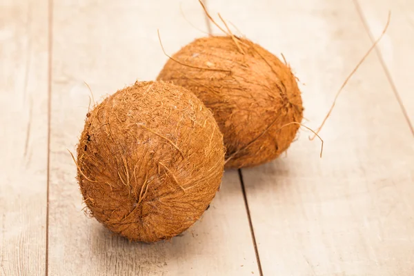Coconuts on wooden table — Stock Photo, Image