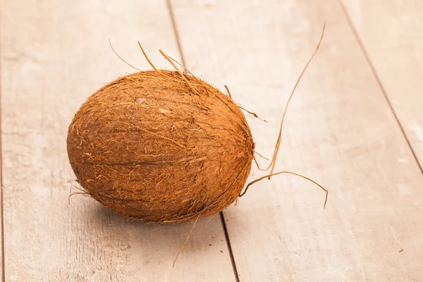 Coconut on wooden table — Stock Photo, Image