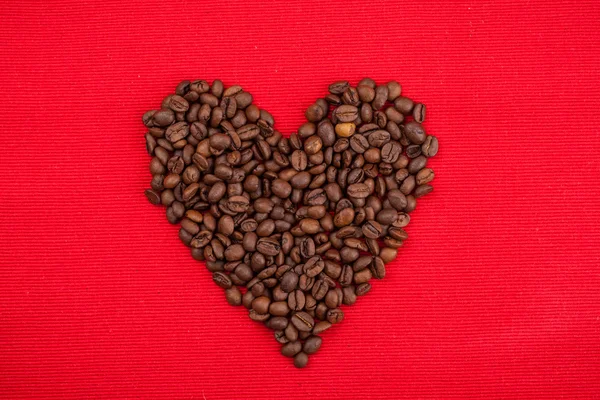 Heart of Coffee beans on red background — Stock Photo, Image