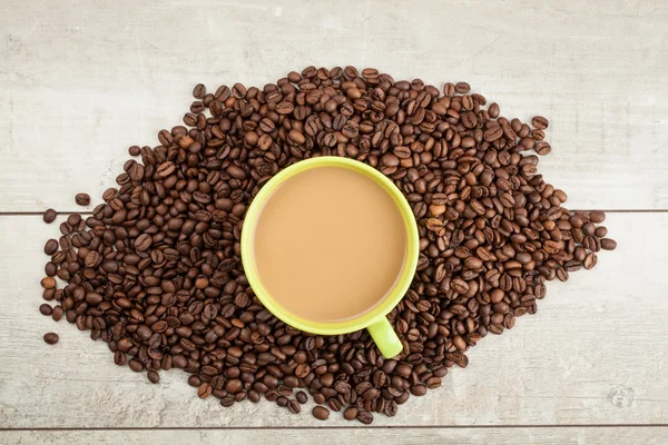 Cup of coffee in coffee beans — Stock Photo, Image