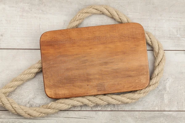 Wooden board with ship rope — Stock Photo, Image