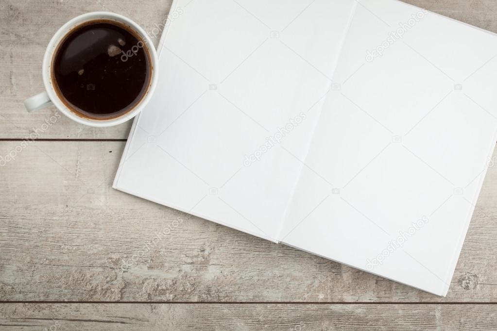 Open book on a table and coffee