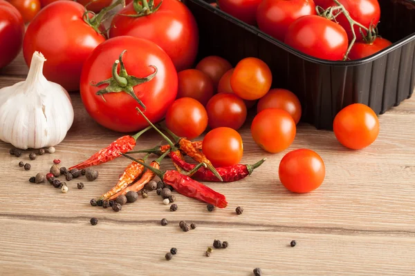 Variety of red tomatoes on table — Stock Photo, Image