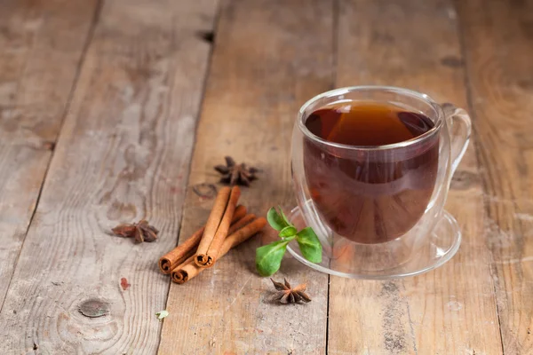 Glass cup of tea with cinnamon sticks — Stock Photo, Image