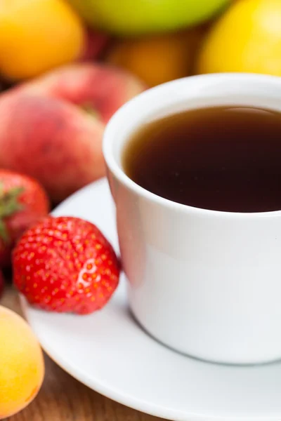 Assortment of fruits with  cup of tea — Stock Photo, Image