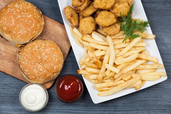 Tasty french fries and hamburgers — Stock Photo, Image