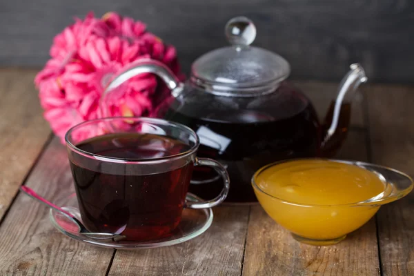 Glass teapot with black tea — Stock Photo, Image