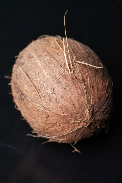 Whole Coconut on black — Stock Photo, Image