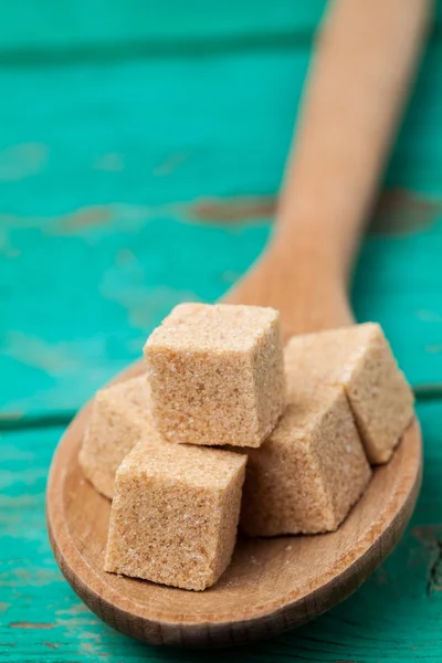 Sugar in wooden spoon — Stock Photo, Image