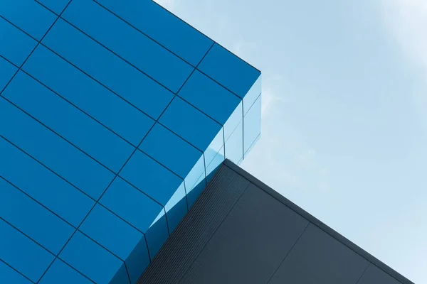 Geometric colored building facade elements with planes, lines and corners with light flare and reflections for an abstract background and texture of white, blue, gray colors. Place for text