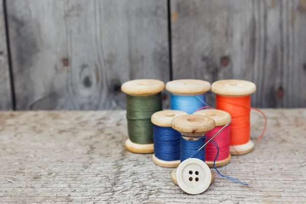 Vintage reels of thread and needle and button — Stock Photo, Image