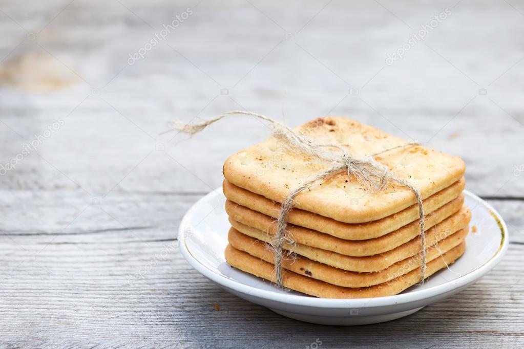 Saltine  crackers on a plate on wooden table
