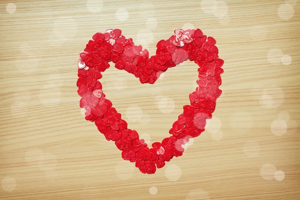 Love heart made with heart-shaped confetti — Stock Photo, Image