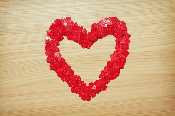 Love heart made with heart-shaped confetti — Stock Photo, Image