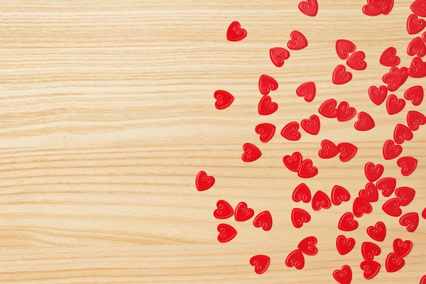 Red hearts confetti on wooden background — Stock Photo, Image