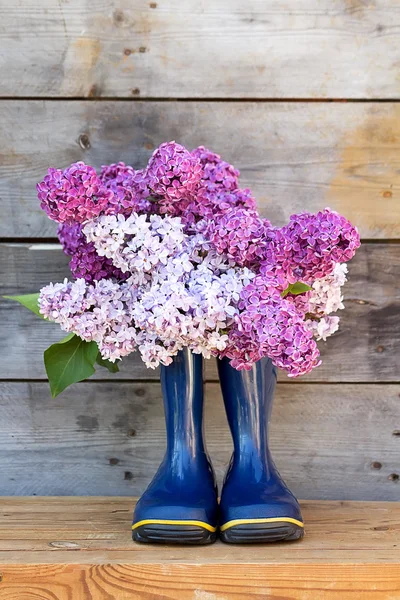 Bouquet de lilas et bottes en caoutchouc — Photo