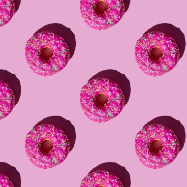 Pembe jöleli donutların deseni yumuşak pembe arka planda renkli kırıntılar serpiştirilmiş.