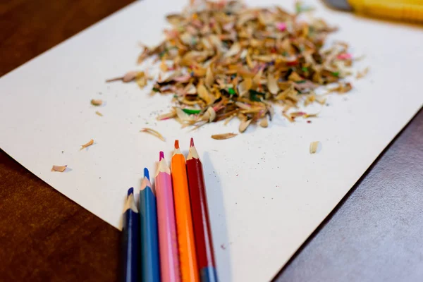 Colored pencils, shavings on a white background and a stationery knife — Stock Photo, Image