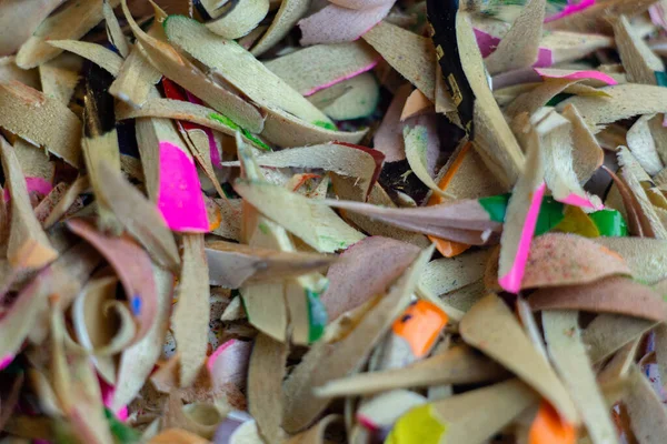 Shavings pensil berwarna pada latar belakang putih. Penembakan makro. — Stok Foto