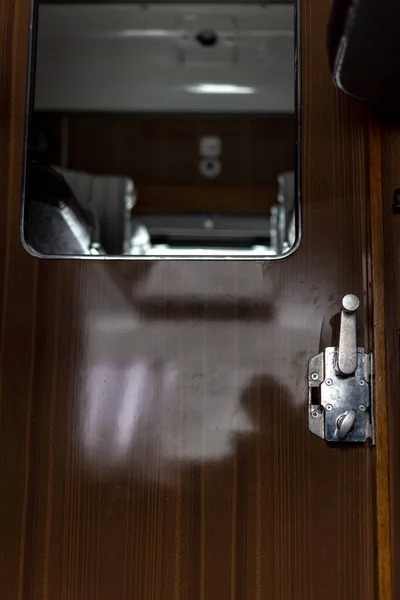 Door and doorknob in a train compartment. Travel by train.