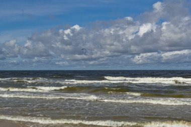 Gün boyunca sahil. Bulutlar ve deniz dalgaları.