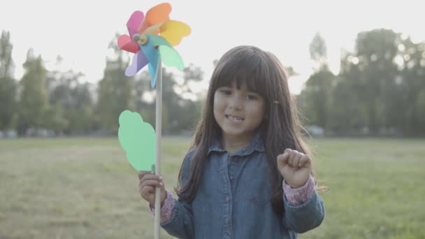 Imádnivaló latin lány fúj papír legyező szabadban — Stock videók