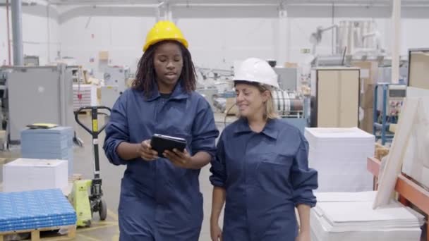 Diverse factory colleagues in protective uniforms — Stock Video