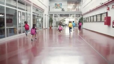 Farklı yaşlarda bir grup çocuk okulda eğleniyor..