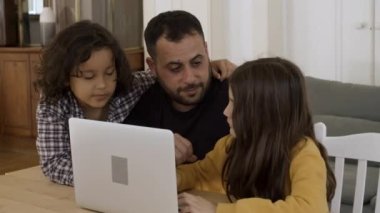 Bekar bir baba çocuklarla bilgisayar kullanıyor..