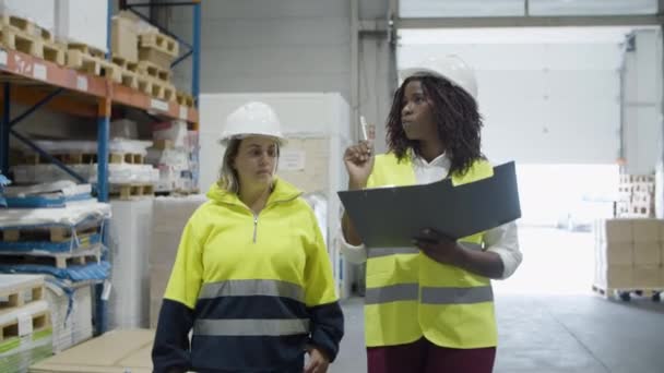 Trabalhadoras diversas e alegres que caminham pelo armazém. — Vídeo de Stock