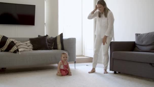 Happy baby in red dungarees crawling on floor. — Stock Video