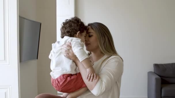 Vrolijke moeder genieten van zoete momenten met zoon thuis. — Stockvideo