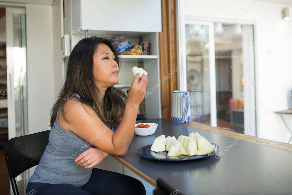 Portrait of calm Japanese woman in kitchen