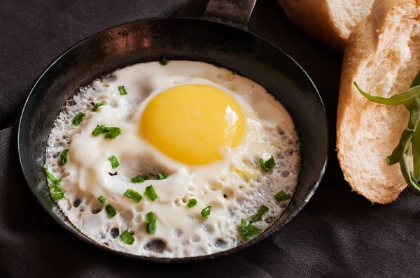 Stekt ägg i stekpanna och skivat bröd — Stockfoto