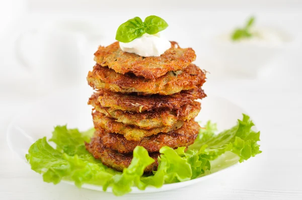 Fried potato pancakes on white background — Stock Photo, Image