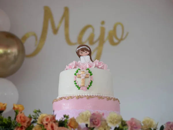 white cake with a doll on top and nice word on the background