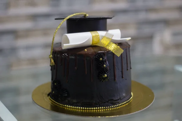 black cake for college degree ceremony with unfocused background