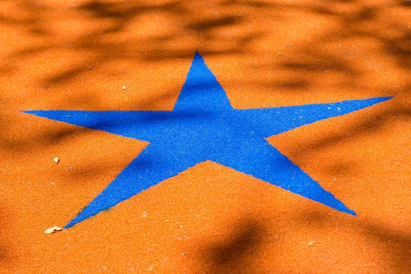 Niebieska Gwiazda Pomarańczowej Macie Podłodze — Zdjęcie stockowe