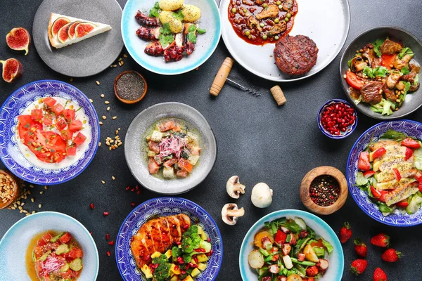 Masa yemeği manzaralı. Tabakları masaya koyun. Uluslararası karışık yiyecekler. Vejetaryen, et ve çiğ et.