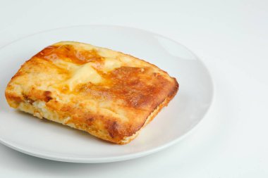 Beyaz tabakta peynirli güveç ve fotokopi alanı. süzme peynir güveç yalıtılmış om beyaz.