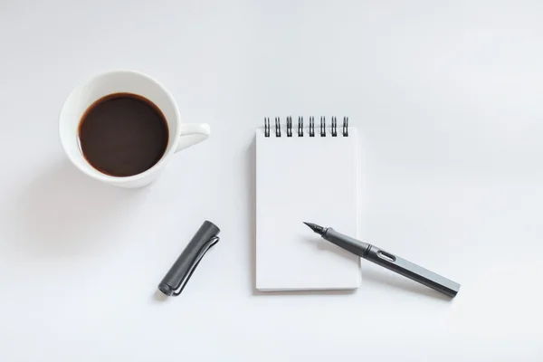 Coffee cup, spiral notebook and pen on white background — Stock Photo, Image