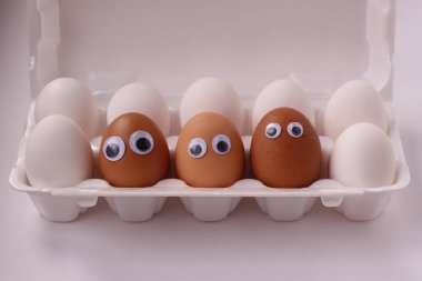 Üç kahverengi yumurta ve bir kutu beyaz yumurta..