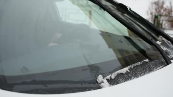 汽车上工作的雨刷把雨雪中的玻璃擦干净了 Kia Sportage Voronezh的挡风玻璃2021年1月6日 坏天气的概念 突如其来的雪 一个男人给一辆汽车保暖 — 图库视频影像