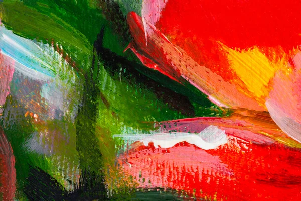 Multi-colored oil painting. Abstract artistic bright background. A fragment of a picture on cardboard. Spring flowers painting. The texture of paint strokes in close-up. Mixing contrast of green red