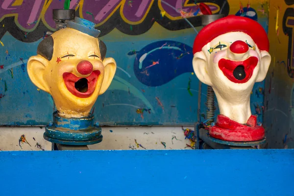 spray water into the mouth of heads of  clowns and win a stuffed character or animal